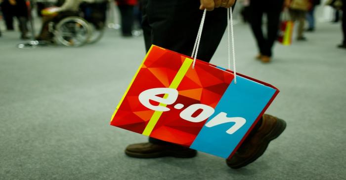 A shareholder carries a bag with the logo of E.ON during the company's annual shareholders