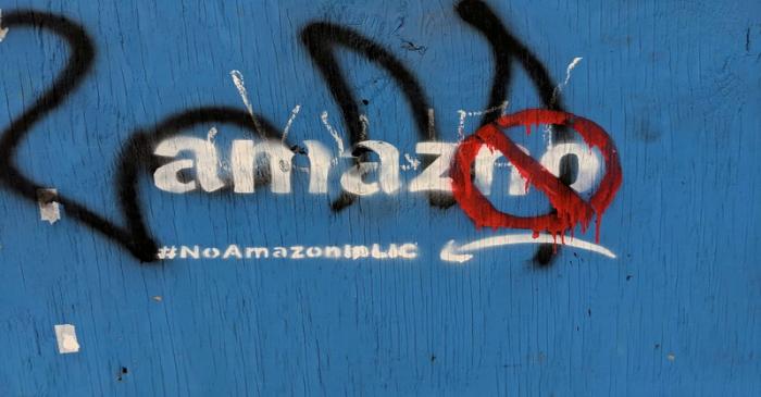 FILE PHOTO: Graffiti opposing the construction of the new Amazon campus covers a fence at a