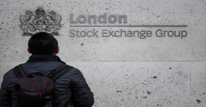 People walk past the London Stock Exchange Group offices in the City of London, Britain