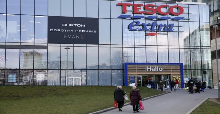 FILE PHOTO: People walking past a Tesco Extra store in Woolwich, southeast London