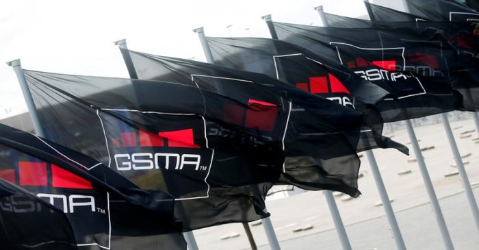 FILE PHOTO: GSMA flags fly at the Mobile World Congress in Barcelona