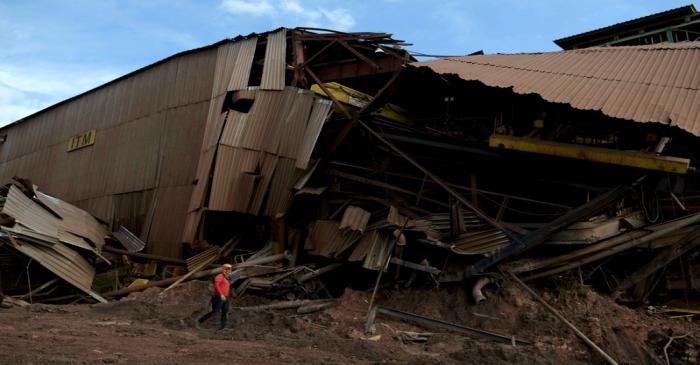 FILE PHOTO: A member of a rescue team walks next to a collapsed tailings dam owned by Brazilian