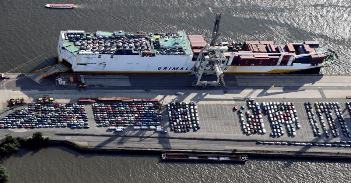 Export cars are loaded on a RoRo ship of Italian Grimaldi Group at a terminal in the port of