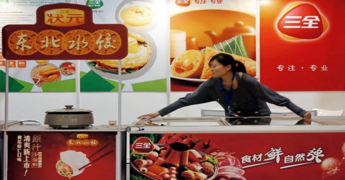 Staff member is seen at the booth of Sanquan Food promoting its dumpling products at a food