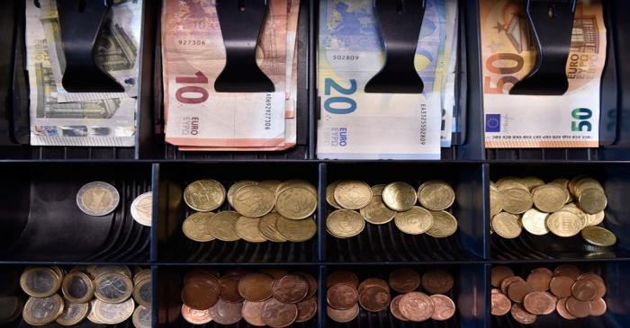 Euro banknotes and coins are displayed in a shop in Brussels