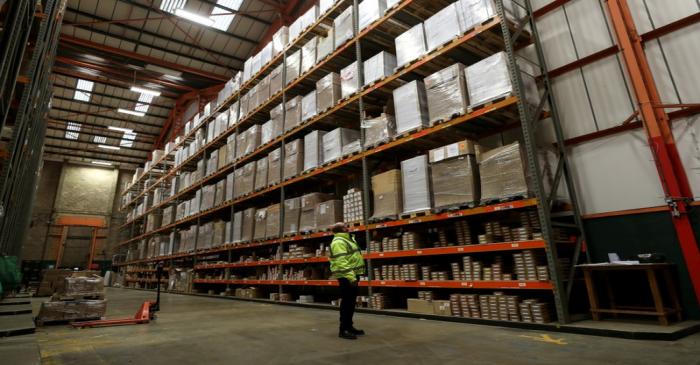 FILE PHOTO: An employee looks up at goods at the Miniclipper Logistics warehouse in Leighton