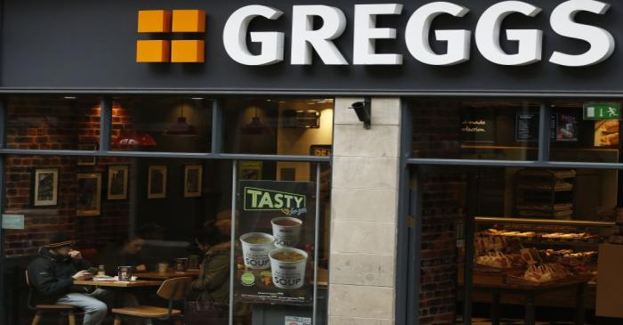People sit inside a Greggs bakery in Bradford, Britain