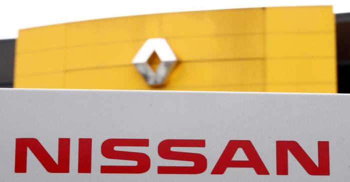 FILE PHOTO: The logos of car manufacturers Renault and Nissan are seen in front of a common