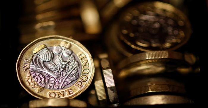 Pound coins are seen in this photo illustration taken in Manchester, Britain