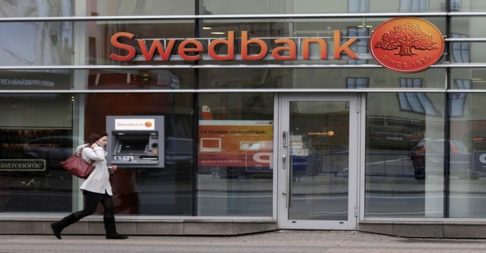 FILE PHOTO: A woman walks past Swedbank  branch in Riga