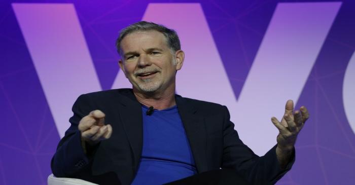 Netflix's CEO Hastings gestures as he delivers his keynote speech during Mobile World Congress