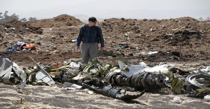 FILE PHOTO: American civil aviation and Boeing investigators search through the debris at the