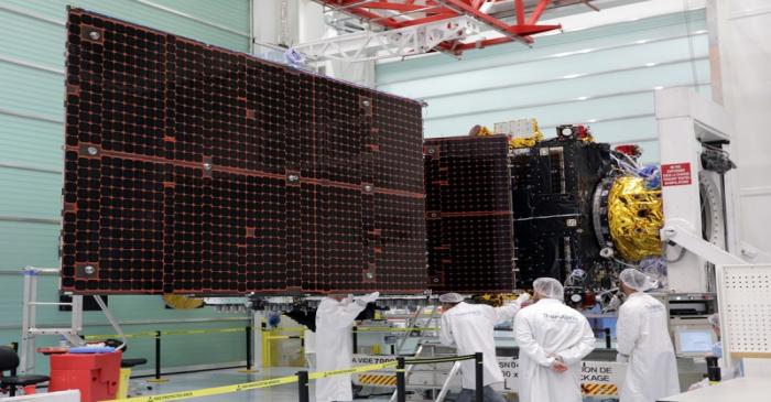 FILE PHOTO: A technician looks at a solar panel on the Inmarsat S-Band/Hellas-Sat 3 satellite