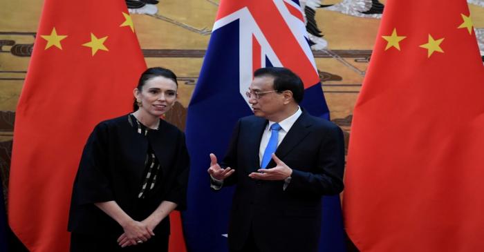 New Zealand Prime Minister Jacinda Ardern listens to Chinese Premier Li Keqiang during a
