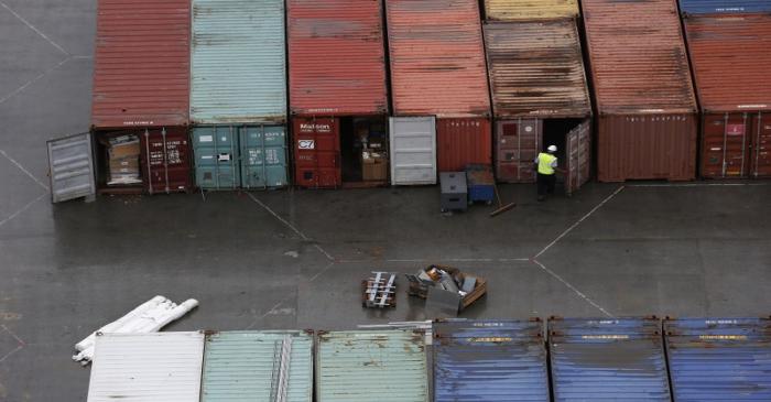 A worker opens the door of a container at DP World London Gateway container port in Essex,