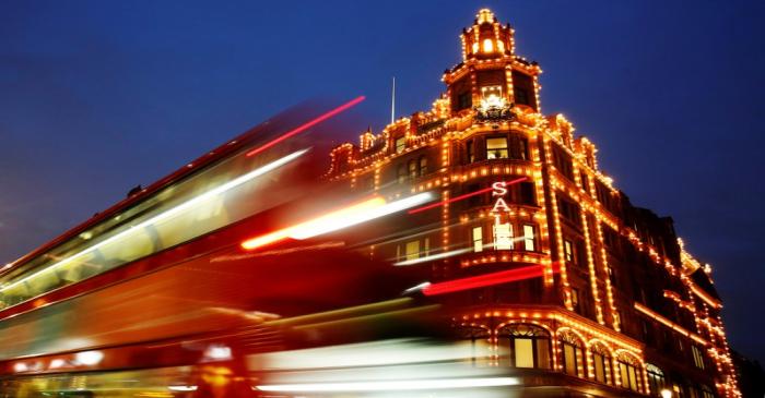 FILE PHOTO: A bus casts light trails as it passes iconic store Harrods in London