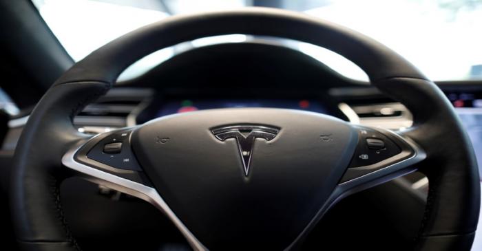 FILE PHOTO: The logo of Tesla is seen on a steering wheel of its Model S electric car at its