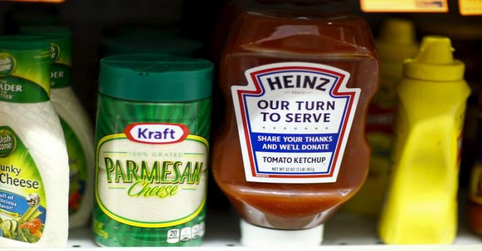 A Heinz Ketchup bottle and a bottle of Kraft parmesan cheese are displayed in a grocery store