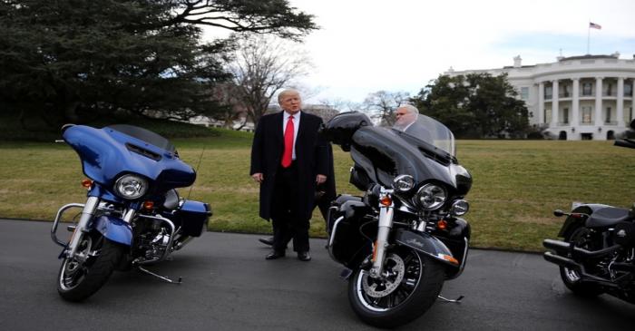 U.S. President Donald Trump and Vice President Mike Pence stands next to Harley Davidson