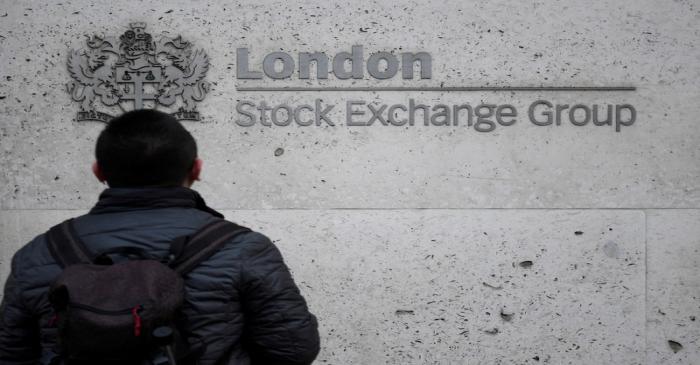 FILE PHOTO: People walk past the London Stock Exchange Group offices in the City of London,