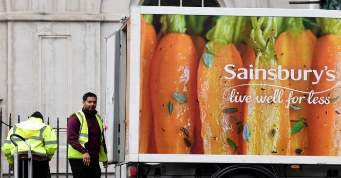 FILE PHOTO: Workers unload a Sainsbury's home delivery van in central London
