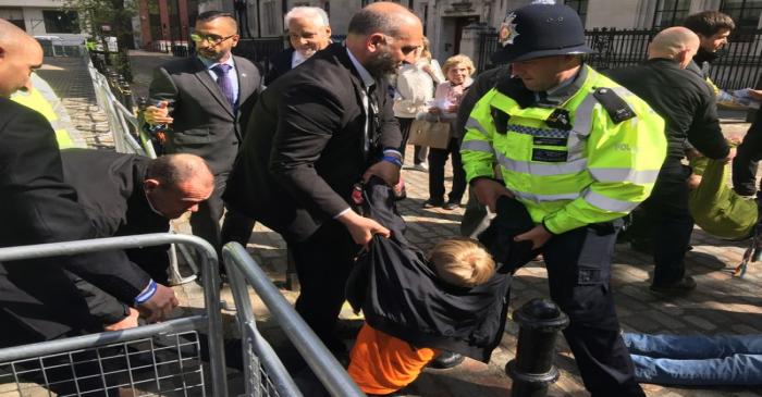 Climate change protesters are dragged away by security outside Barclays annual investor meeting