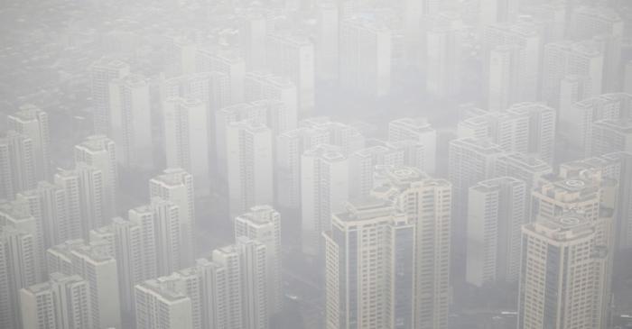 FILE PHOTO: Apartment complexes are seen shrouded by fine dust during a polluted day in Seoul