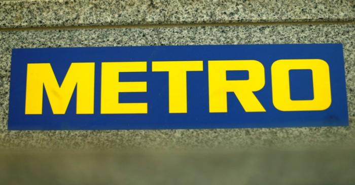 FILE PHOTO: German retailer Metro AG sign is seen on the steps of their headquarters in
