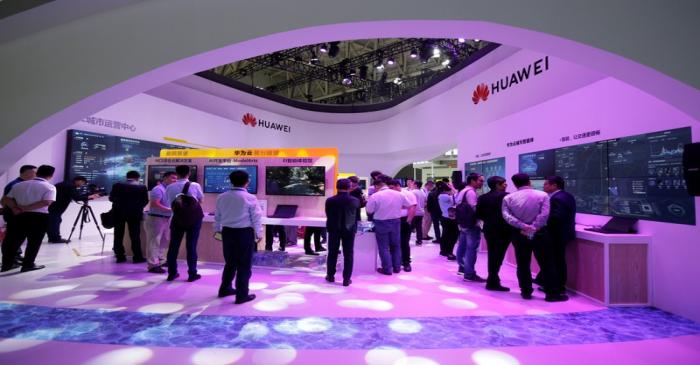 People visit Huawei's booth at an exhibition during the World Intelligence Congress in Tianjin