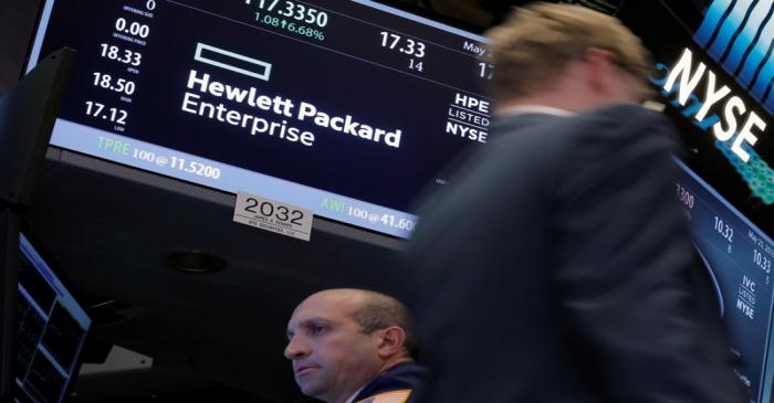 FILE PHOTO: A trader passes by the post where Hewlett Packard Enterprise Co., is traded on the
