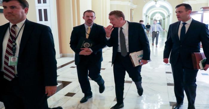 FILE PHOTO: U.S. Trade Representative Lighthizer speaks to an aide after he leaves a meeting