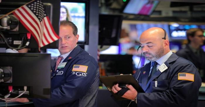 Traders work on the floor at the NYSE in New York