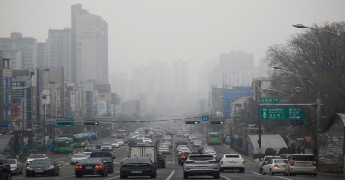 FILE PHOTO: Vehicles move on a road on a polluted day in Seoul