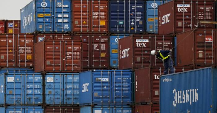 FILE PHOTO: A laborer works in a container area at a port in Tokyo