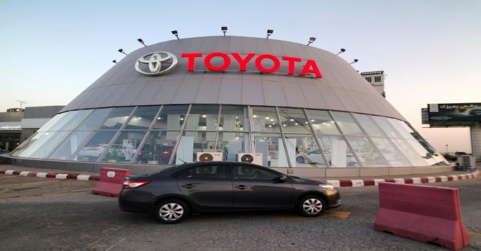A car passes in front of Toyota dealer in Dhahran, Saudi Arabia