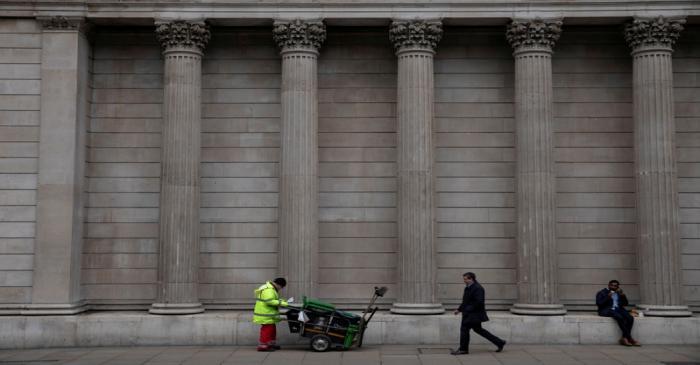 FILE PHOTO: People are seen outside the Bank of England in London