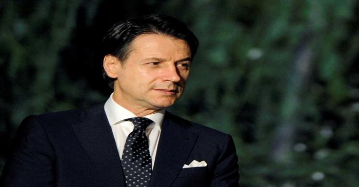 FILE PHOTO: Italy's Prime Minister Giuseppe Conte awaits to welcome participants as they arrive