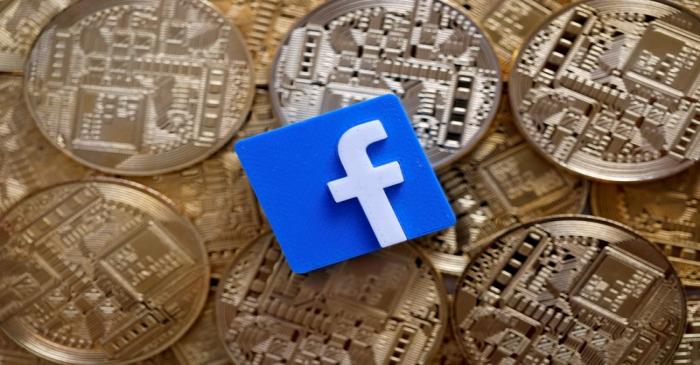 FILE PHOTO: Facebook logo is seen on representations of Bitcoin virtual currency in this