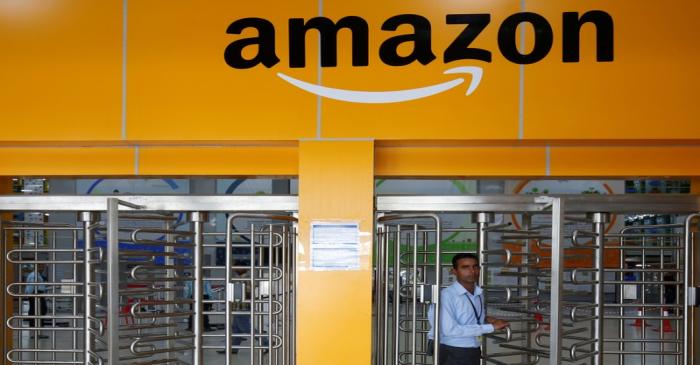 An employee of Amazon walks through a turnstile gate inside an Amazon Fulfillment Centre (BLR7)