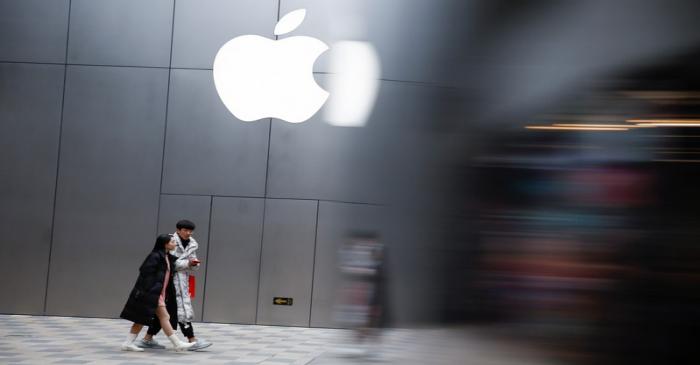 People walk past an Apple store in Beijing