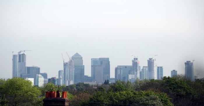FILE PHOTO: The Canary Wharf financial district is seen above a residential rooftop in London