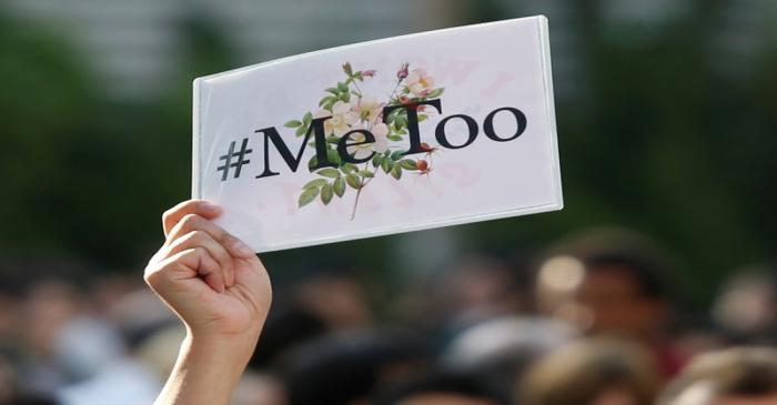 A protester raises a placard reading 