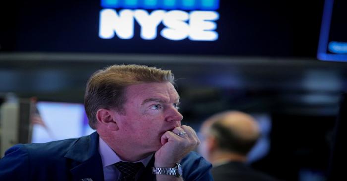 FILE PHOTO: Traders work on the floor at the NYSE in New York