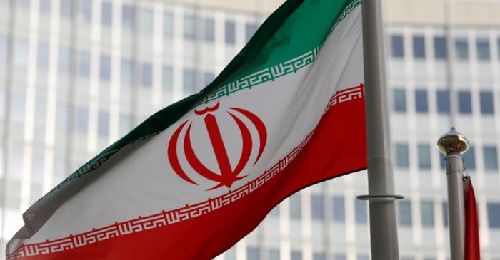 FILE PHOTO: The Iranian flag flutters in front the International Atomic Energy Agency (IAEA)