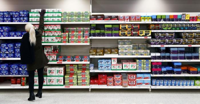 FILE PHOTO: A shopper reaches for a box of tea in a supermarket in London