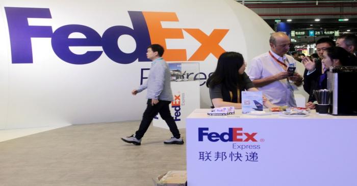 People visit a FedEx Express booth during the China International Import Expo (CIIE) in