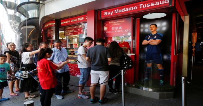 Tourists line up to buy tickets for Madame Tussauds in Hong Kong