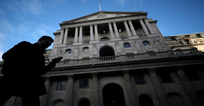 FILE PHOTO: A man walks past the Bank of England in the City of London