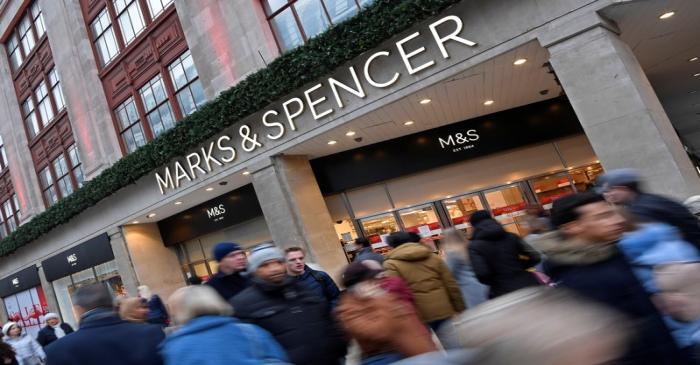 Shoppers walk past Marks and Spencer on Oxford Street in London