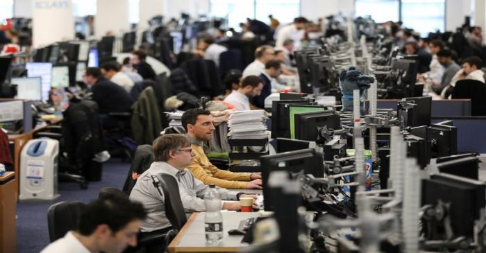 Traders work on the trading floor of Barclays Bank at Canary Wharf in London
